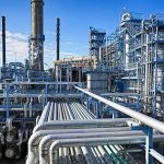 Venezuela Oil ‘Control’ Claim Sparks Fury Industrial refinery with pipelines and distillation towers under blue sky