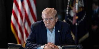 Taxpayers Paid for THIS Trump TV Ad Donald Trump seated at a table between two desk phones