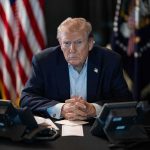 Trump Just Left the UN Speechless Donald Trump seated at a table between two desk phones