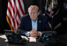 Trump Just Left the UN Speechless Donald Trump seated at a table between two desk phones