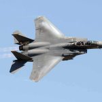 fighter jet banking in clear sky
