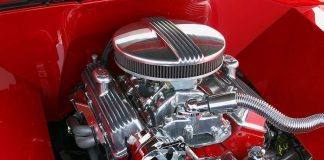 Close-up of a shiny chrome engine inside a red car