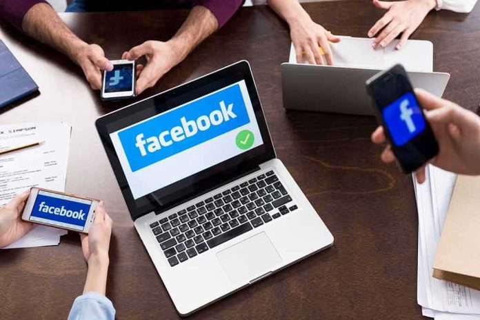 shutterstock_641039665-2 Laptop with Facebook on screen surrounded by smartphones