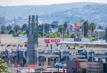 The Mexican Cartels Have an ‘Extermination Ranch’ Border crossing booths at Mexico entry point with cityscape in background