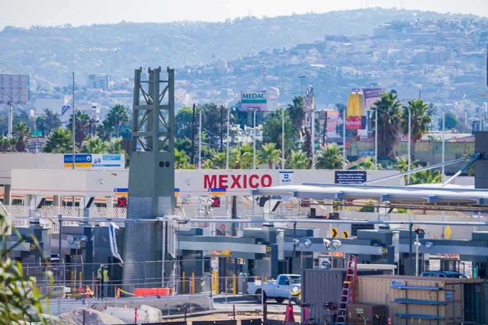 Border crossing booths at Mexico entry point with cityscape in background