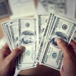 Trump Found a Way to Cancel $810 Million Hands counting US hundred-dollar bills