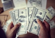 Trump Found a Way to Cancel $810 Million Hands counting US hundred-dollar bills