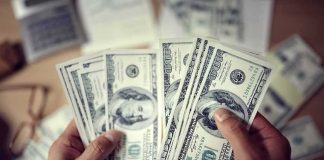 Trump Found a Way to Cancel $810 Million Hands counting US hundred-dollar bills