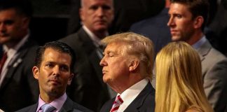 Donald Trump Jr. and Donald Trump standing among a crowd at an event