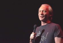 Maher Walk-Back On Trump STUNS Political Base comedian holding a microphone on stage
