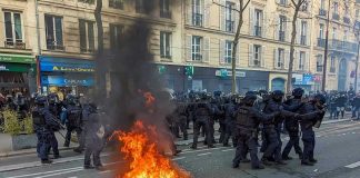 Restaurant Owner Fights Back Against Paris LOOTERS Fire burning on the street amid police presence.