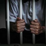 Transgender Teacher CONVICTED Over ‘Murder Spree’ Threats person gripping prison bars