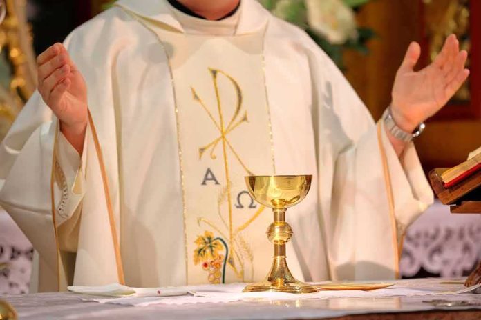 Priest celebrating Mass with chalice and open hands