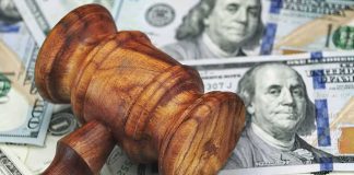 Foreign Campus Donors Stay HIDDEN Wooden judge's gavel on scattered US dollar bills