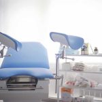 Viral TikTok Mom Appears to Book ABORTION Gynecological exam chair with blue padding in a clinic room