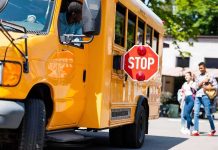 School Bus Rolls Away With 19 KIDS Aboard School bus with extended stop sign near students on sidewalk