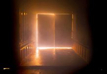 Light streaming through a slightly open industrial door