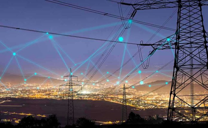 Power transmission towers over a city at dusk with connected network lines