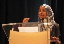 Ilhan Omar speaking at a podium with a microphone
