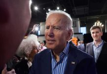 Joe Biden greets people at an indoor event