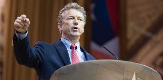 Rand Paul Blocks KOSA Fast-Track Attempt Man in suit speaking at a podium with a microphone