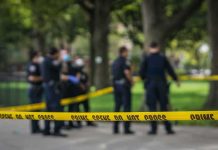NAACP Calls Family’s Halloween Yard RACIST crime scene tape with police officers in a park