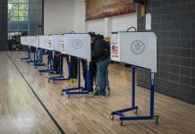 Why California Mail Ballots Could Get TOSSED Voters at polling booths in a gymnasium