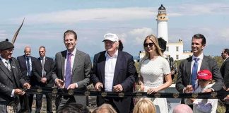 Donald Trump, Ivanka Trump, Eric Trump, and Donald Trump Jr. at outdoor ribbon cutting by lighthouse