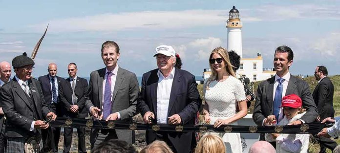 Donald Trump, Ivanka Trump, Eric Trump, and Donald Trump Jr. at outdoor ribbon cutting by lighthouse