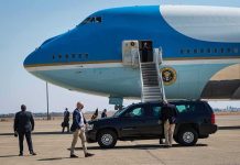 Nicki Minaj Boards AIR FORCE ONE Security detail near blue and white aircraft with staircase and SUV