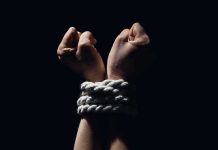 Woman Tortured for 7 HOURS Hands bound with white rope against dark background