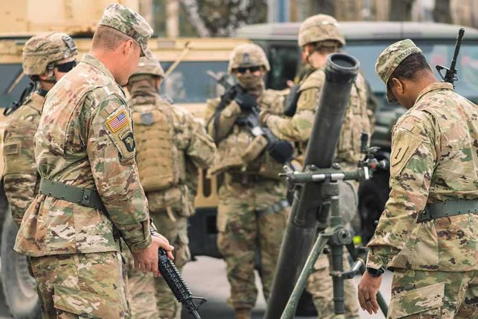 Soldiers in camouflage gather around a mortar during field training