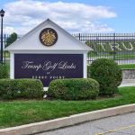 Entrance sign at a golf course with manicured shrubs