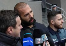 168 Files Put Andrew Tate in DEEPER Trouble Man speaking to reporters with microphones outside a building