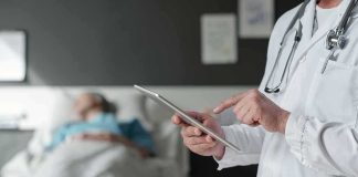 Pope Leo Waits on CANCER Test After Surgery Doctor using tablet beside hospital patient