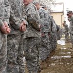 Trump Overrules HEGSETH on Fort Hood Execution Soldiers in camouflage uniforms stand in two facing rows outdoors