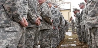 Trump Overrules HEGSETH on Fort Hood Execution Soldiers in camouflage uniforms stand in two facing rows outdoors