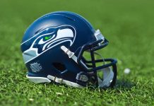 NFL Team’s Logo Compared to NAZI Imagery American football helmet on grass