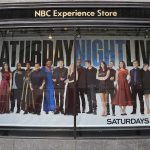SNL Host Goes After Cancel Culture in WILD Monologue Storefront window with large SNL poster featuring Leslie Jones, Bobby Moynihan, Michael Che, Shirley Ellis, Kenan Thompson, and Richard Z. Kruspe