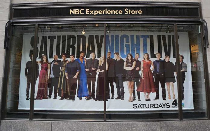 Storefront window with large SNL poster featuring Leslie Jones, Bobby Moynihan, Michael Che, Shirley Ellis, Kenan Thompson, and Richard Z. Kruspe
